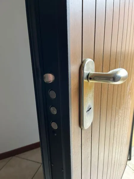 Porta blindata aperta con i chiavistelli in vista, intervento a Malalbergo